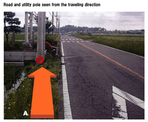 Road and utility pole seen from the traveling direction